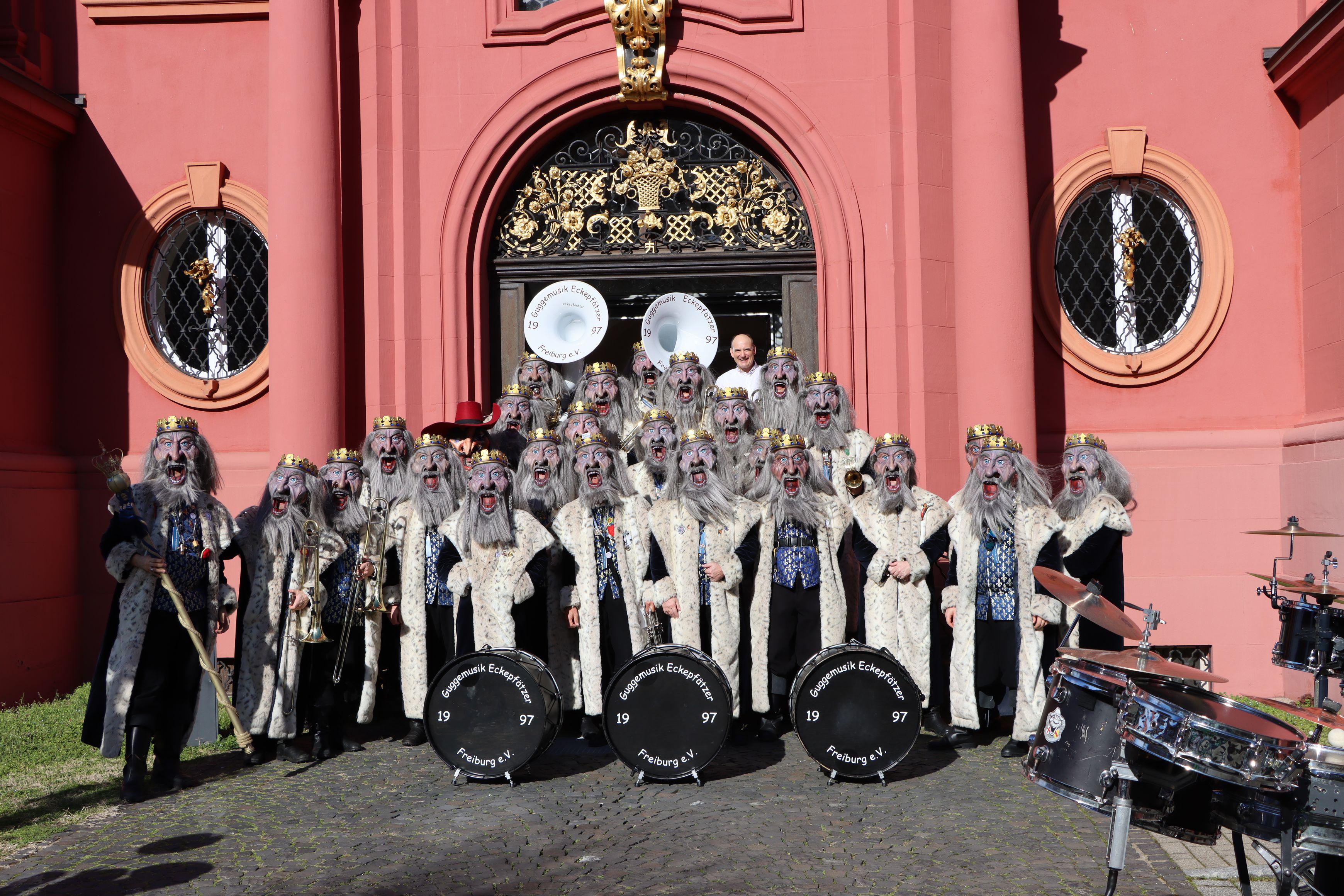 Gruppenbild der Eckepfätzer im Königskostüm vor einer Kirche